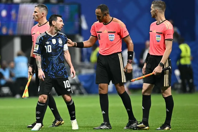Argentina's forward #10 Lionel Messi (2ndL) speaks with US referee Ismail Elfath (2ndR) during the 2026 World Cup football tournament semi-final match between England and Argentina at the Atlanta Stadium in Atlanta on July 15, 2026.