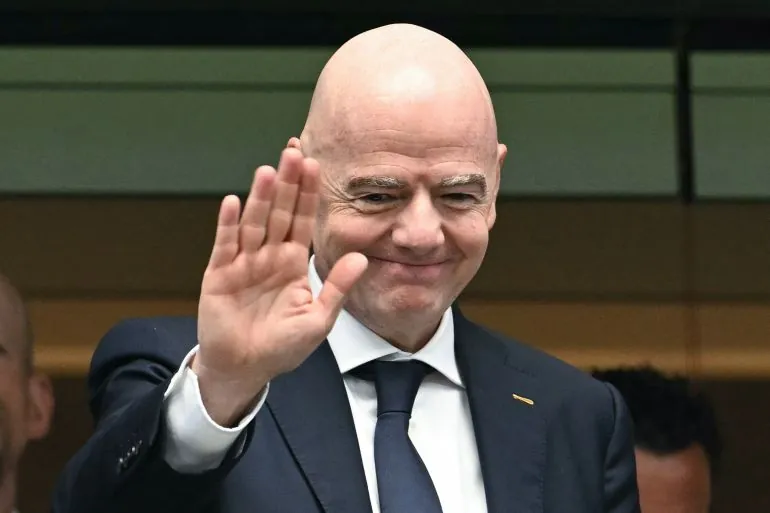 FIFA President Gianni Infantino gestures from the stands ahead of the 2026 World Cup football tournament semi-final match between France and Spain at the Dallas Stadium in Arlington on July 14, 2026.